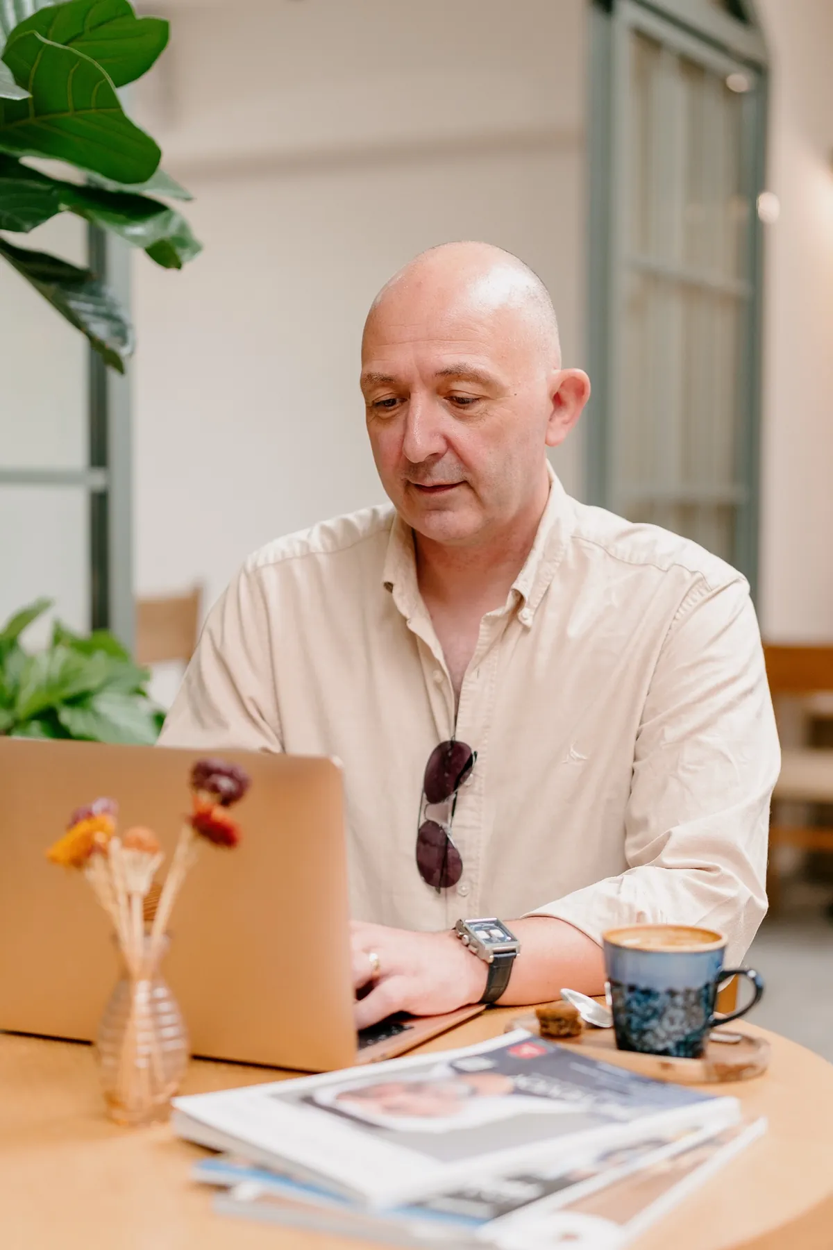 Kevin Martin working at his laptop, a coffee beside him.